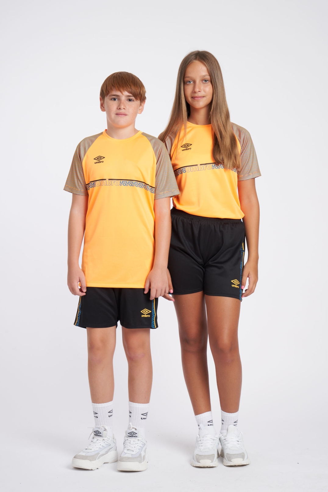 CAMISETA UMBRO SPIRITO JERSEY  JNR ORANGE POP / BLACK / PETROL BLUE